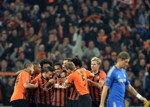 FC Shakhtar Donetsk's Alex Teixeira is congratulated by teammates after scoring